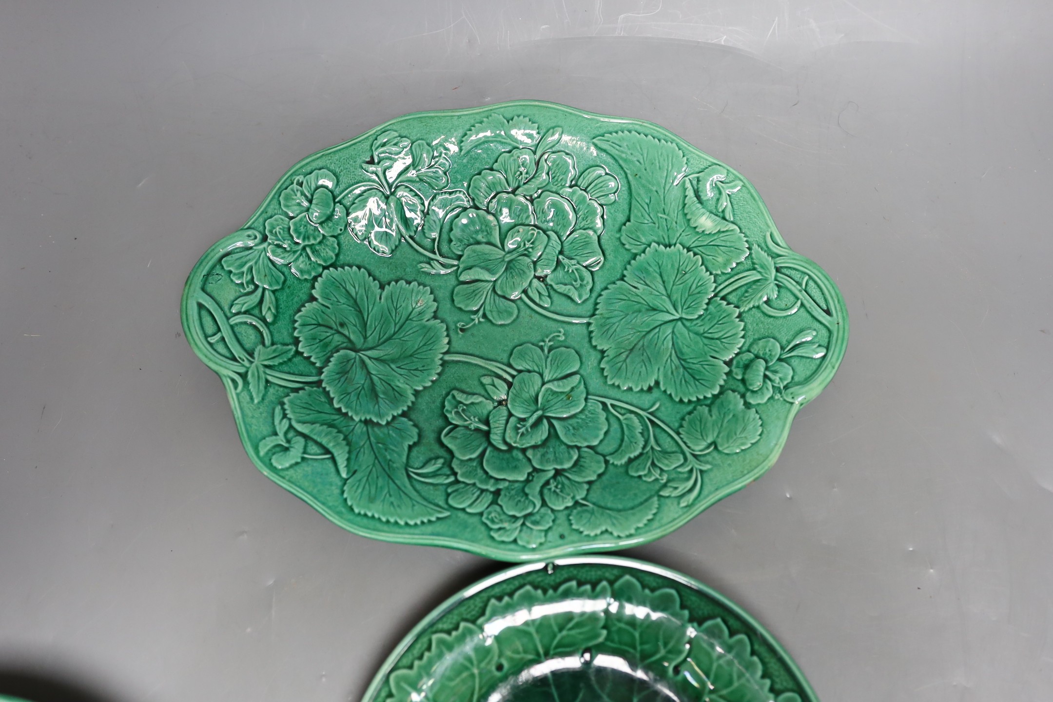 A collection of 19th century greenware leaf plates and a dish